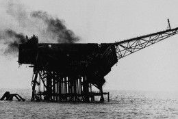 Smoke rises from the burnt out shell of the Piper Alpha oil platform in the North Sea off the coast of Aberdeen, Scotland, July 7, 1988. More than 150 oil rig workers died, when the rig exploded and caught fire Wednesday night. (AP Photo)