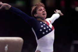 Kerri Strug, of Houston, Texas, reacts after badly landing on her left leg following her vault routine at the women's team gymnastics competition at the Centennial Summer Olympic Games in Atlanta on Tuesday, July 23, 1996.   (AP Photo/John Gaps III)