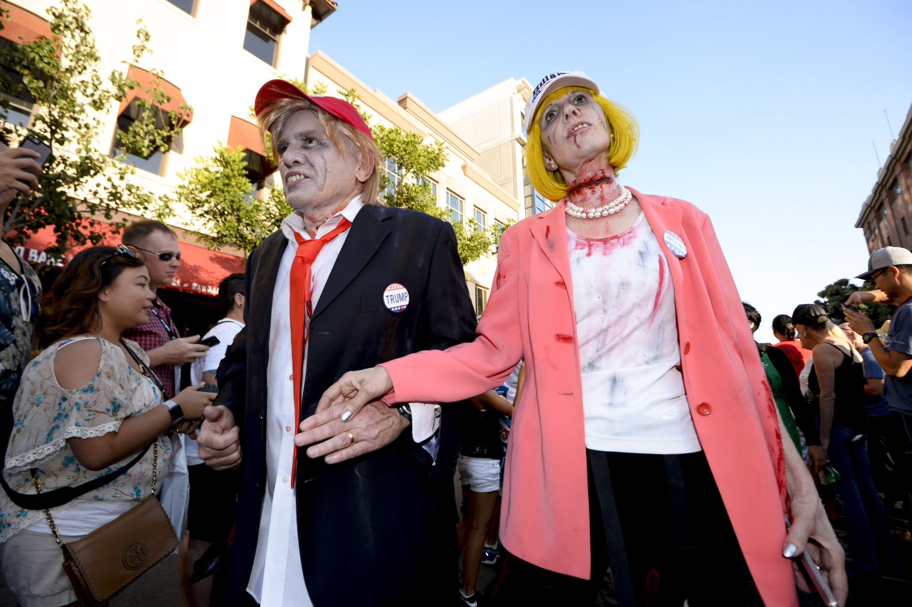 Husband and wife Dave Hester and Donna Hester, dressed as zombie Donald Trump and zombie Hillary Clinton, walk down Fifth Avenue as they take part in the Zombie Walk on day three of the Comic-Con International held at the San Diego Convention Center Saturday July 23, 2016 in San Diego.  (Photo by Denis Poroy/Invision/AP)