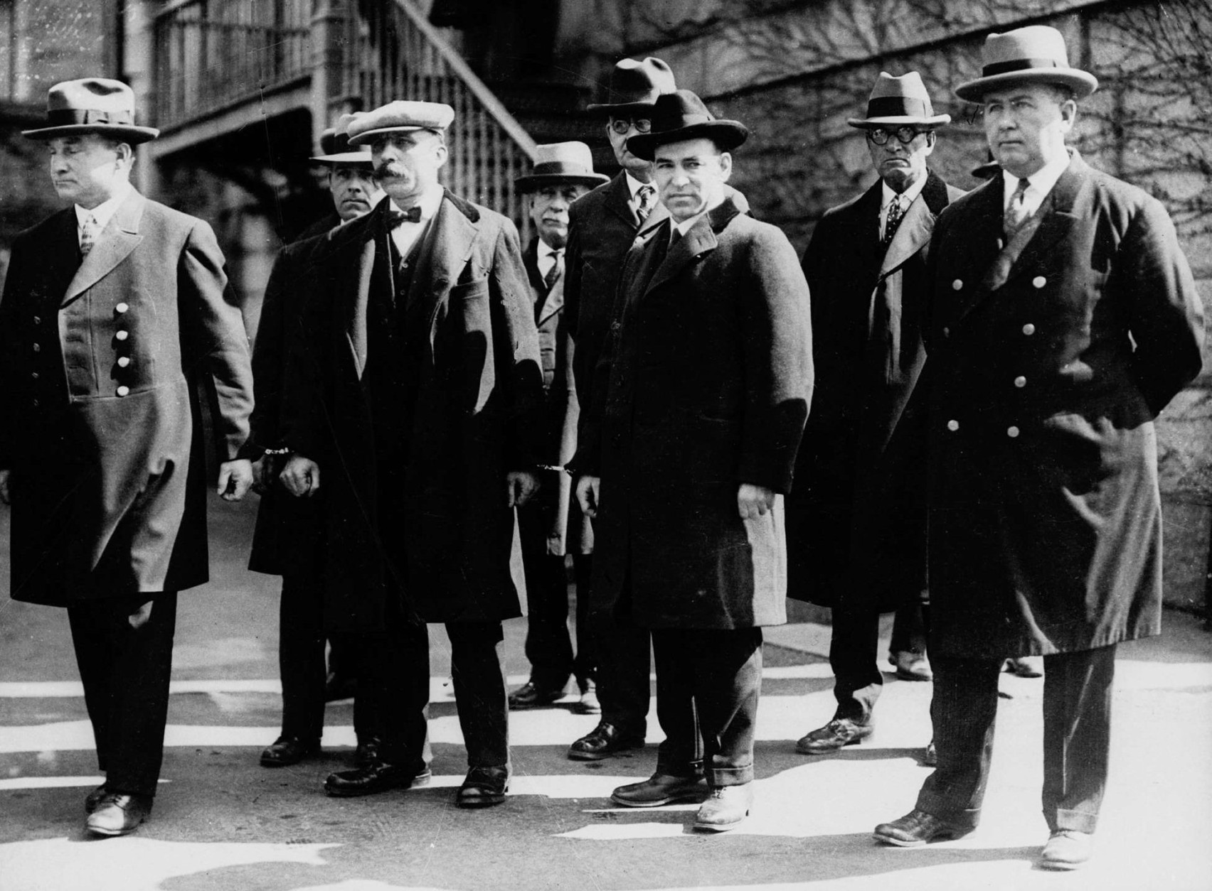 FILE-- Italian immigrants Nicola Sacco, second from right foreground, and Bartolomeo Vanzetti, second from left foreground, stand in handcuffs with unidentified escorts in Massachusetts around 1927. Sacco and Vanzetti, arrested in 1920, were accused of killing a  paymaster and guard in Braintree, and stealing about $16,000.  Many believed they were convicted because of their anarchistic beliefs. Their scheduled execution was protested by ordinary and prominent men and women. The city of Boston will usea bronze sculpture of Sacco and Vanzetti to say the two men, executed 70 years ago, did not get a fair trial, said Mayor Thomas M. Menino, Tuesday, Aug. 19, 1997. On the anniversary of the executions, Saturday, Aug. 23, 1997, Menino will commission the sculpture which is to be in place by the year 2000, but it has not been  decided where. (AP Photo/File)