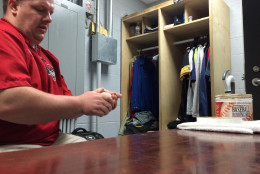 Daniel Rose, home clubhouse manager for the Double-A Erie Seawolves, rubs baseballs before a recent game. (WTOP/Noah Frank)