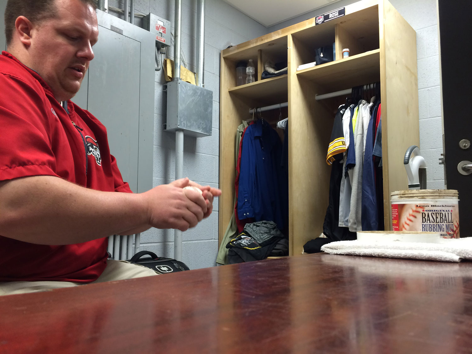 Daniel Rose, home clubhouse manager for the Double-A Erie Seawolves, rubs baseballs before a recent game. (WTOP/Noah Frank)
