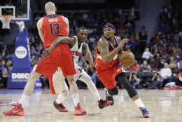 Washington Wizards center Marcin Gortat (13) sets a screen for guard Bradley Beal (3) as Detroit Pistons guard Kentavious Caldwell-Pope (5) chases during the second half of an NBA basketball game, Friday, April 8, 2016, in Auburn Hills, Mich. (AP Photo/Carlos Osorio)