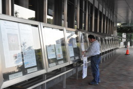 Every morning, Mike Machado prints and hangs the front pages of newspapers from the U.S. and across the world outside the Newseum on Pennsylvania Avenue. (WTOP/Rachel Nania) 