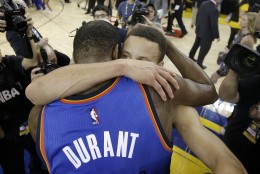 Oklahoma City Thunder forward Kevin Durant, foreground, hugs Golden State Warriors guard Stephen Curry after Game 7 of the NBA basketball Western Conference finals in Oakland, Calif., Monday, May 30, 2016. The Warriors won 96-88. (AP Photo/Marcio Jose Sanchez)