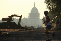 WASHINGTON, DC - JULY 21: The US Capitol can be seen as a jogger runs along the National Mall that is currently under construction, on July 21, 2016 in Washington, DC. Washington area temperatures are forecasted to reach the upper 90s for the next few days. (Photo by Mark Wilson/Getty Images)