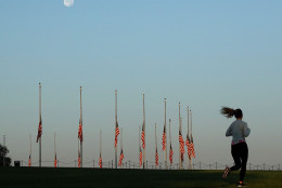 WASHINGTON, DC - JULY 21: A jogger runs through the grounds of the Washington Monument where the flags are at half staff, on July 21, 2016 in Washington, DC. Washington area temperatures are forecasted to reach the upper 90s for the next few days. (Photo by Mark Wilson/Getty Images)