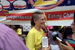 Winner Molly Schuyler is all smiles after topping her previous record, eating 28 burgers for this year's competition. (WTOP/Ginger Whitaker)