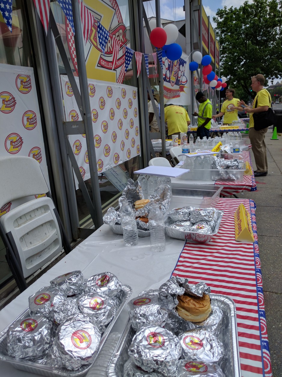 The aftermath: trays of uneaten hamburgers remain after the contest ends. (WTOP/Ginger Whitaker)