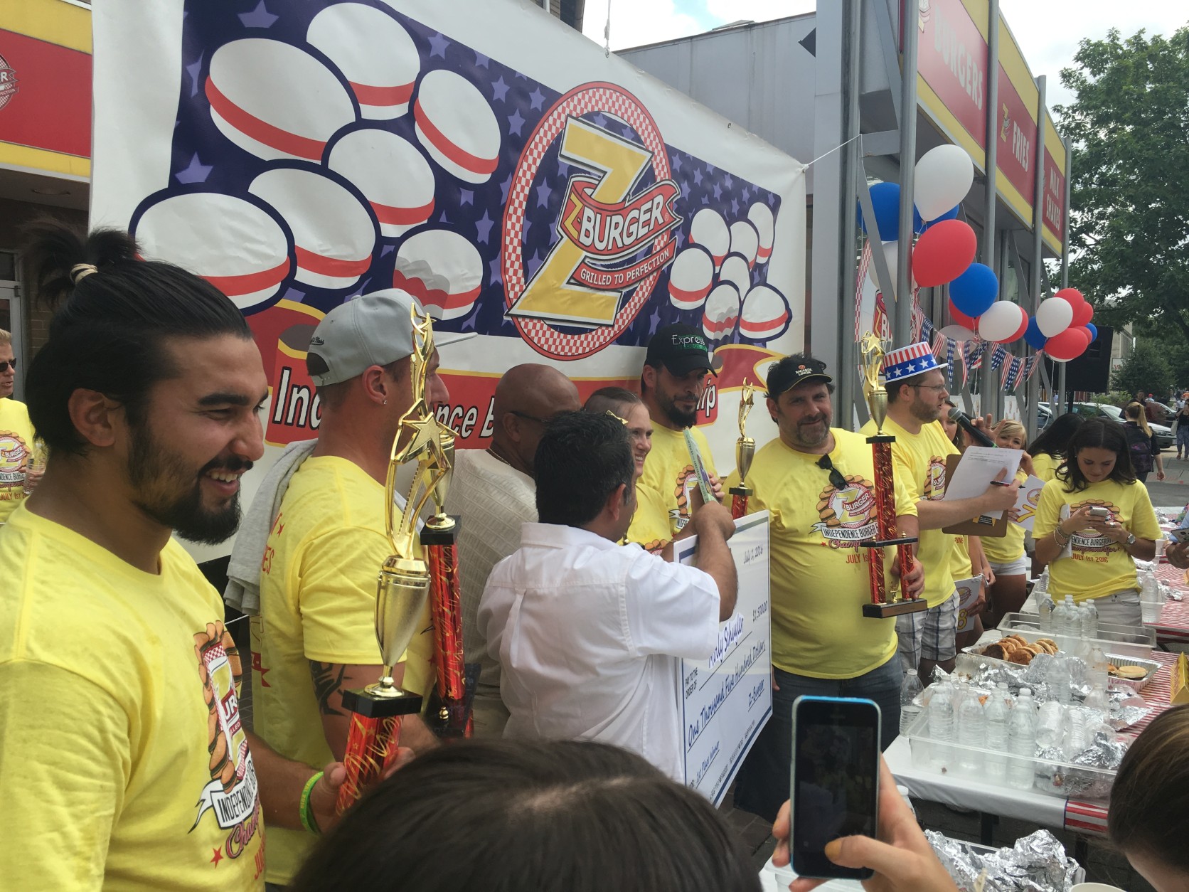The winners gather to collect their prizes and trophies after keeping the burgers down for two minutes. (WTOP/Mike Murillo)