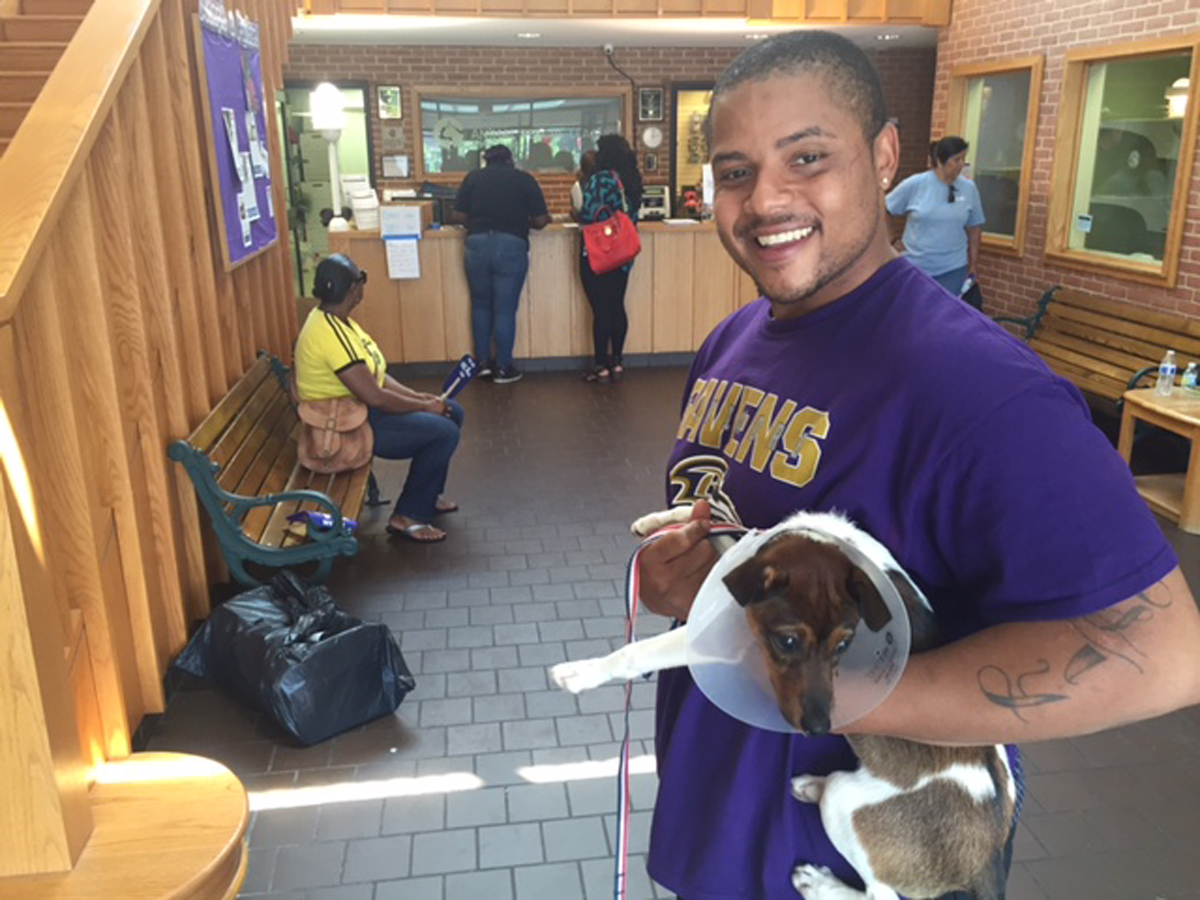 Malik Elam of NE D.C. holds Bullet, his new jack russell terrier. As part of the nationwide "Clear the Shelters" event, D.C.-area animal shelters waived adoption fees for the day of Saturday, July 23, 2016. (WTOP/John Domen)
