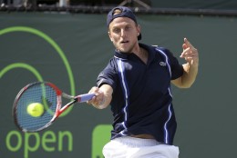 Denis Kudla returns to Milos Raonic during their match at the Miami Open tennis tournament, Saturday, March 26, 2016, in Key Biscayne, Fla. (AP Photo/Lynne Sladky)