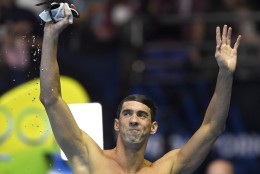 Michael Phelps waves to fans after the men's 100-meter butterfly at the U.S. Olympic swimming trials, Saturday, July 2, 2016, in Omaha, Neb. (AP Photo/Mark J. Terrill)
