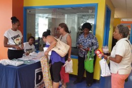 Residents pick up Zika prevention kits at Columbia Heights Community Center in D.C. on Saturday, July 16, 2016. (WTOP/Kathy Stewart)