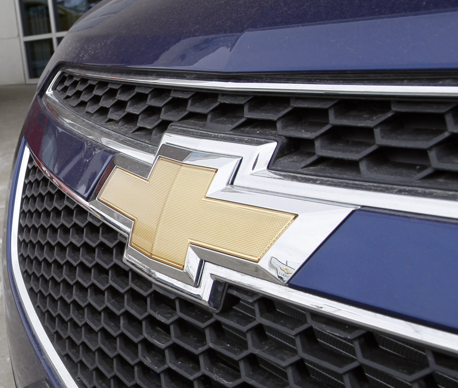 FILE - This Feb. 19, 2012 file photo shows the familiar Chevrolet bowtie logo displayed on the grille of a 2012 Cruze sedan, foreground, with a 2012 Sonic sedan in the background at a Chevrolet dealership in the south Denver suburb of Englewood, Colo. Sunday, Nov. 18, 2012, marks the anniversary of GM's initial public stock offering in November 2010. The company has made money for 11 straight quarters, piling up more than $16 billion in profits. Its cars and trucks are selling for good prices. And sales are strong in China. (AP Photo/David Zalubowski, File)