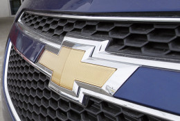 FILE - This Feb. 19, 2012 file photo shows the familiar Chevrolet bowtie logo displayed on the grille of a 2012 Cruze sedan, foreground, with a 2012 Sonic sedan in the background at a Chevrolet dealership in the south Denver suburb of Englewood, Colo. Sunday, Nov. 18, 2012, marks the anniversary of GM's initial public stock offering in November 2010. The company has made money for 11 straight quarters, piling up more than $16 billion in profits. Its cars and trucks are selling for good prices. And sales are strong in China. (AP Photo/David Zalubowski, File)