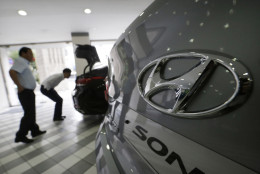 The logo of Hyundai Motor Co. is seen on a vehicle displayed at the company's showroom in Seoul, South Korea, Tuesday, July 26, 2016. Hyundai Motor Co. says its second-quarter income fell from a year earlier for a tenth straight quarter.(AP Photo/Ahn Young-joon)