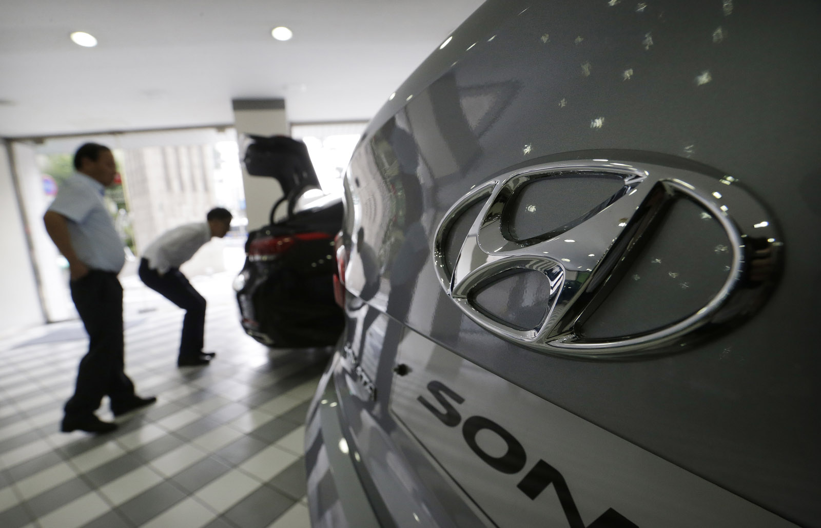 The logo of Hyundai Motor Co. is seen on a vehicle displayed at the company's showroom in Seoul, South Korea, Tuesday, July 26, 2016. Hyundai Motor Co. says its second-quarter income fell from a year earlier for a tenth straight quarter.(AP Photo/Ahn Young-joon)