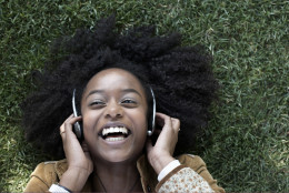 Woman listening to music on headphones (Getty images)