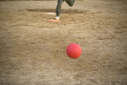 A red kickball rolls toward home plate after it is pitch - the person pictured here on plate is approaching the kick. (Thinkstock)