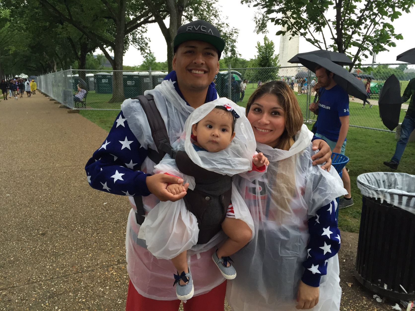 A family is prepared for rain on the National Mall on Monday, July 4, 2016. (WTOP/Michelle Basch)