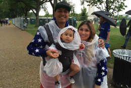 A family is prepared for rain on the National Mall on Monday, July 4, 2016. (WTOP/Michelle Basch)