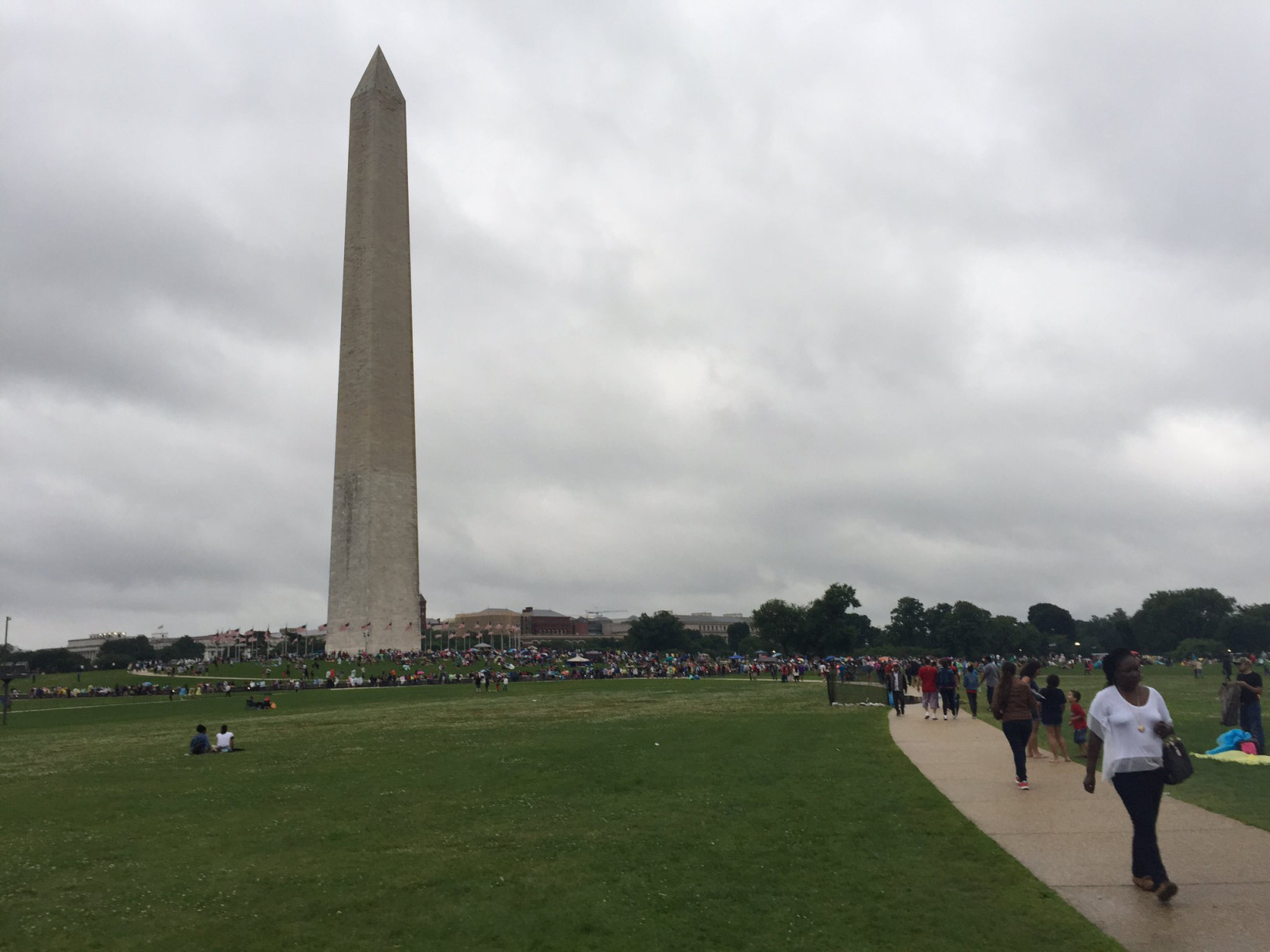 The Washington Monument is seen as crowds gathered in early July. (WTOP/Michelle Basch)