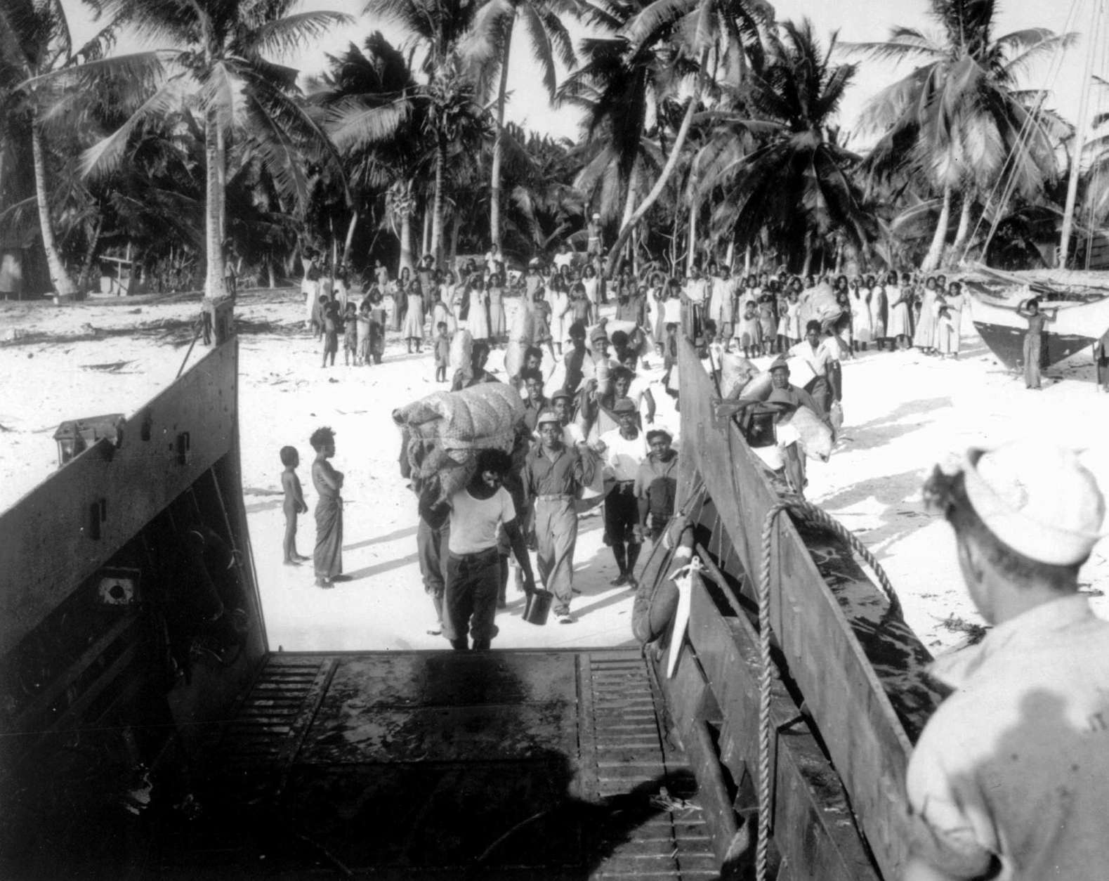 An advance team of Bikini men board a landing craft to assist U.S. Navy Seabees in building new homes for the islanders on Rongerik. The Bikinians had to evacuate their island before "Operation Crossroads," the U.S. military's nuclear test blasts at Bikini atoll in July, 1946. (AP Photo)