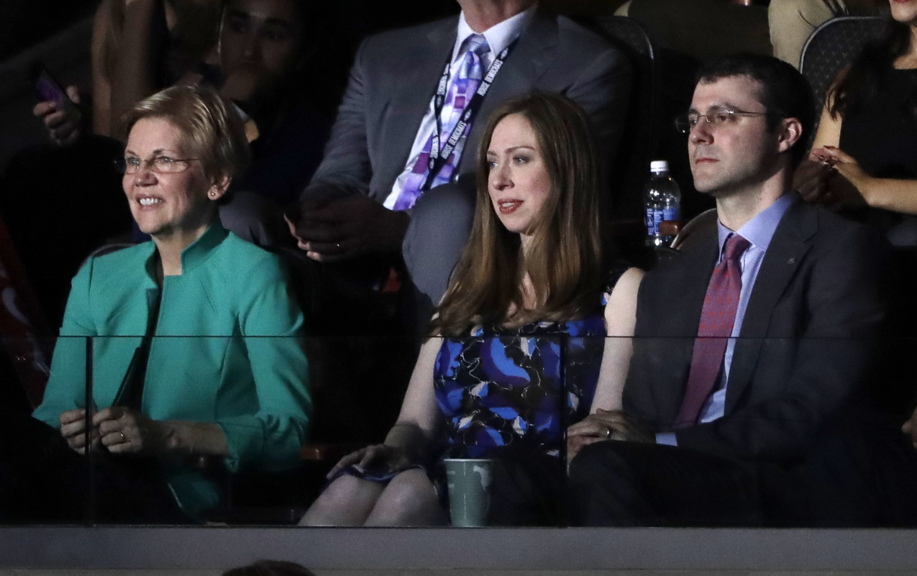 Chelsea Clinton, daughter of Democratic Presidential candidate Hillary Clinton, left, watches alongside her husband Marc Mezvinsky as her father speaks during the second day session of the Democratic National Convention in Philadelphia, Tuesday, July 26, 2016. At left is Sen. Elizabeth Warren, D-Mass. (AP Photo/Matt Rourke)
