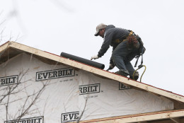 In this Tuesday, Jan. 26, 2016, photo, a man installs a roof on a new home under construction in Atlanta. On Tuesday, Feb. 16, 2016, the National Association of Home Builders/Wells Fargo releases its February index of builder sentiment. (AP Photo/John Bazemore)