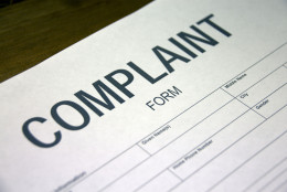 Someone filling out a complaint registration form. (Thinkstock)