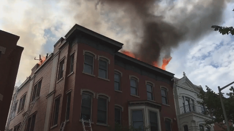 A two-alarm fire started on the roof of a building near 12th and N streets in Northwest at about 4:15 p.m. and the blaze extended into a top floor apartment. (Courtesy D.C. Fire and EMS)