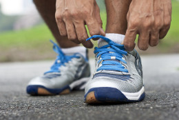 Man bending down to tie his sports shoes. (Thinkstock)