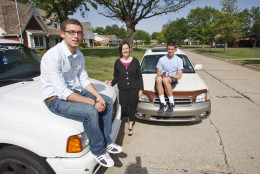 In this May 17, 2011 photo, David Helm, left, Molly Helm, center, and Harrison Maud pose with the boys' automobiles in Enid, Okla. As every driver quickly learns, operating costs are just the beginning. Add in ownership costs like insurance and registration fees and the costs quickly climb _ to an average $8,776 per year, or 58.5 cents per mile, for a car driven 15,000 miles annually.(AP Photo/Sue Ogrocki)