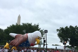 Parade participants hold on to a balloon bald eagle to keep it from flying off during the National Independence Day Parade on Monday,July 4, 2016. (Dick Uliano/WTOP)
