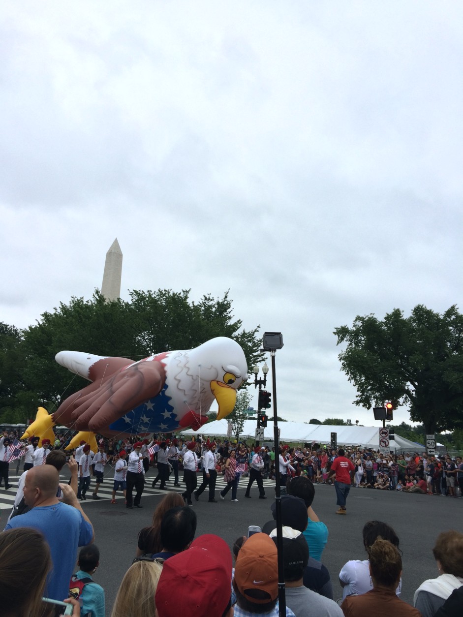 Parade participants hold on to a balloon bald eagle to keep it from flying off during the National Independence Day Parade on Monday,July 4, 2016. (Dick Uliano/WTOP)