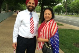 Jgjit and Baljit Ahuja, of Washington, D.C., show their patriotic spirit during the National Independence Day Parade on Monday, July 4, 2016. (Dick Uliano/WTOP)