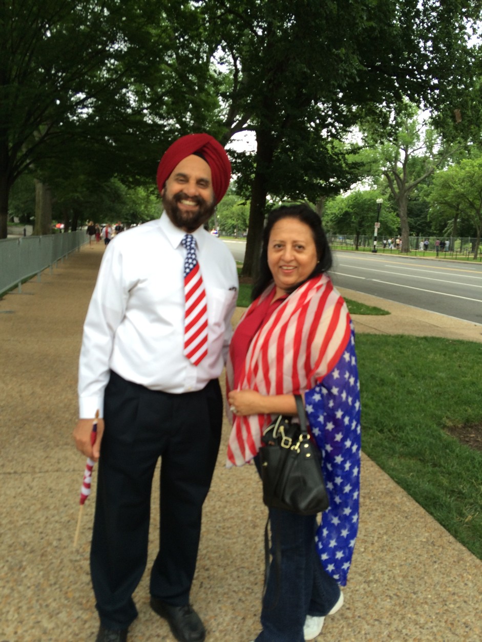 Jgjit and Baljit Ahuja, of Washington, D.C., show their patriotic spirit during the National Independence Day Parade on Monday, July 4, 2016. (Dick Uliano/WTOP)
