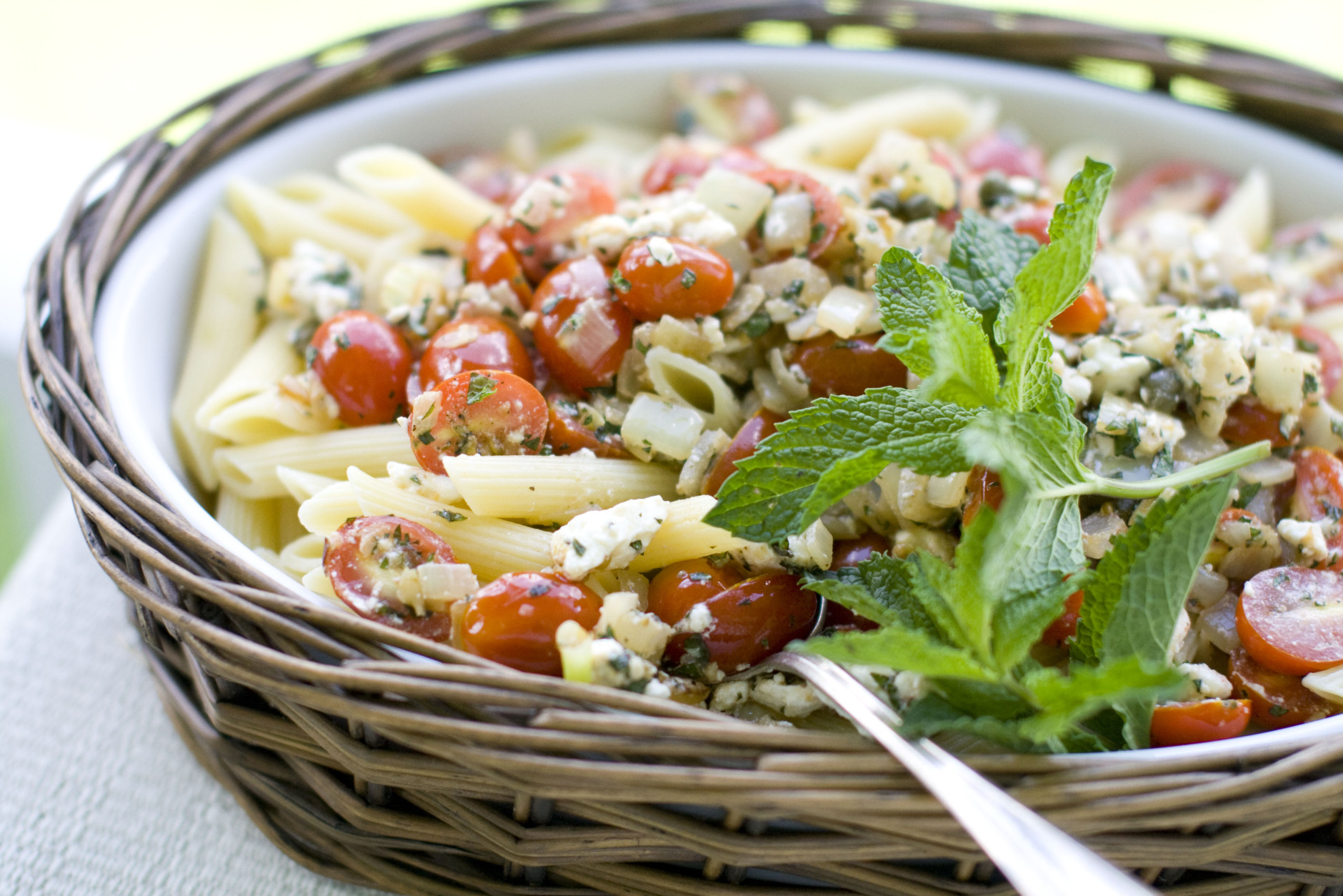 In this May 25, 2011 image taken in Concord, N.H., a dish of feta-mint penne with tomatoes and capers is shown. Many people dont realize that fresh mint has a savory side. It adds tons of fresh, peppery flavor. (AP Photo/Matthew Mead)