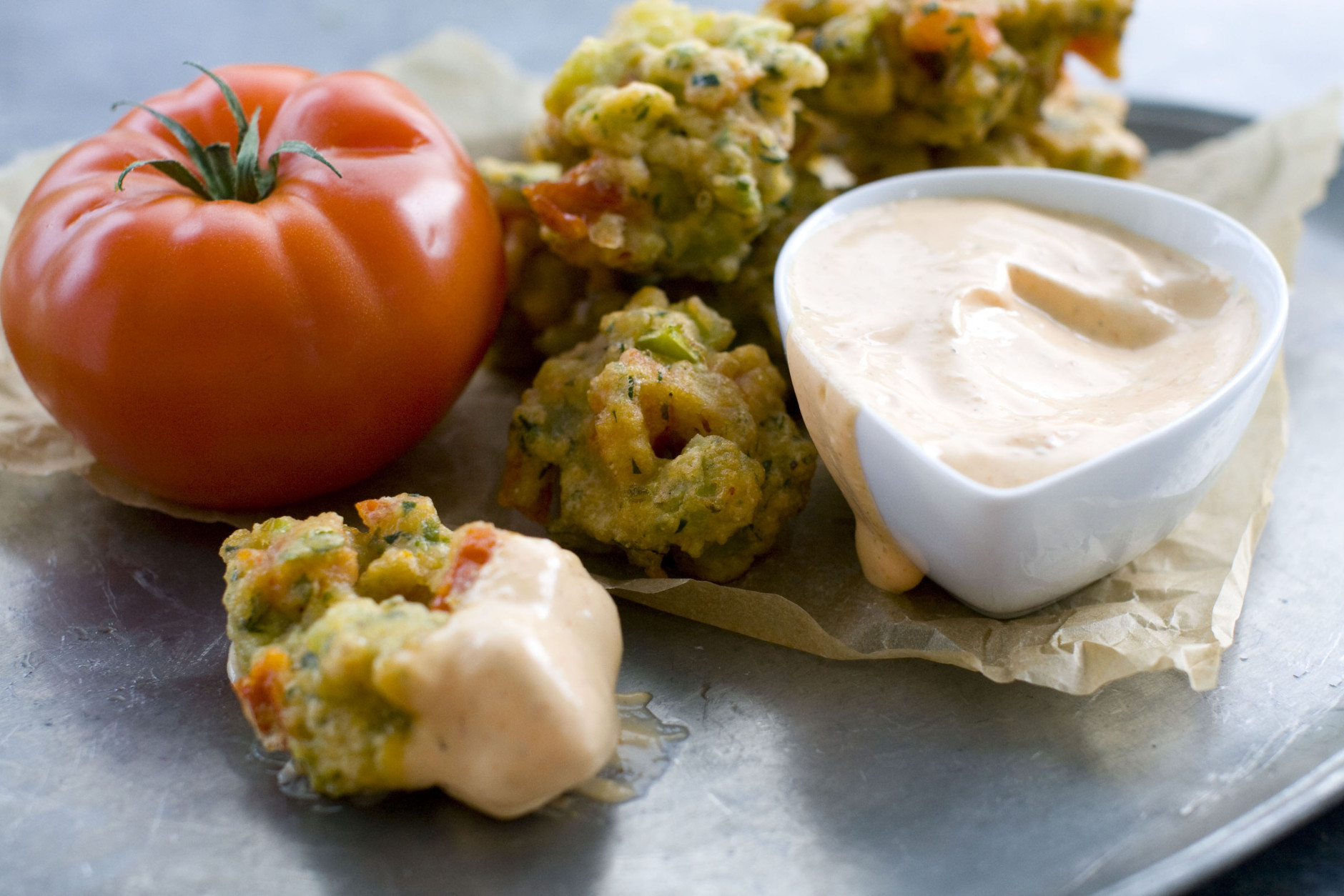 This Aug. 1, 2011 photo shows tomato confetti fritters in Concord, N.H. Serve these fritters with prepared mayonnaise.     (AP Photo/Matthew Mead)