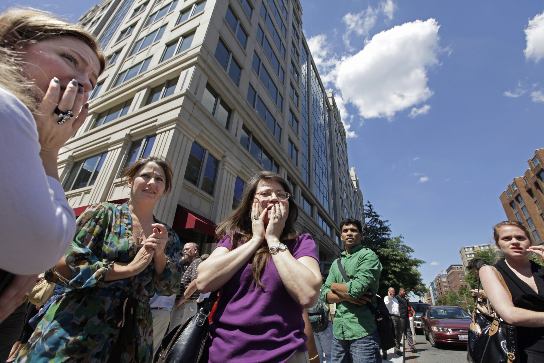 Office workers gather on the sidewalk in downtown Washington, Tuesday, Aug. 23, 2011, moments after a 5.9 magnitude tremor shook the nation's capitol. The earthquake centered northwest of Richmond, Va., shook much of Washington, D.C., and was felt as far north as Rhode Island and New York City.  (AP Photo/J. Scott Applewhite)