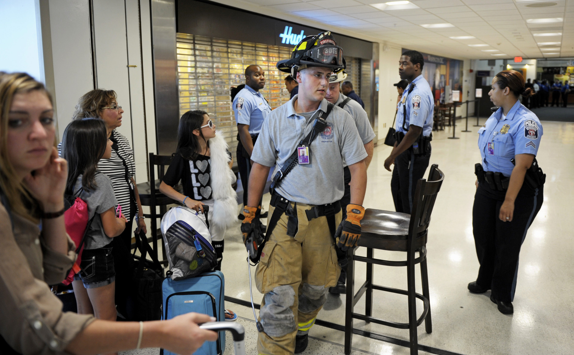 Ronald Reagan National Airport Police stop travelers from entering Terminal A, Tuesday, Aug. 23, 2011, as the airport's fire department checks for damage after an earthquake in the Washington area. A 5.9 magnitude earthquake centered in Virginia forced evacuations of all the monuments on the National Mall in Washington and rattled nerves from Georgia to Martha's Vineyard, the Massachusetts island where President Barack Obama is vacationing. No injuries were immediately reported.  (AP Photo/Cliff Owen)