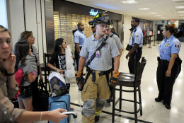 Ronald Reagan National Airport Police stop travelers from entering Terminal A, Tuesday, Aug. 23, 2011, as the airport's fire department checks for damage after an earthquake in the Washington area. A 5.9 magnitude earthquake centered in Virginia forced evacuations of all the monuments on the National Mall in Washington and rattled nerves from Georgia to Martha's Vineyard, the Massachusetts island where President Barack Obama is vacationing. No injuries were immediately reported.  (AP Photo/Cliff Owen)