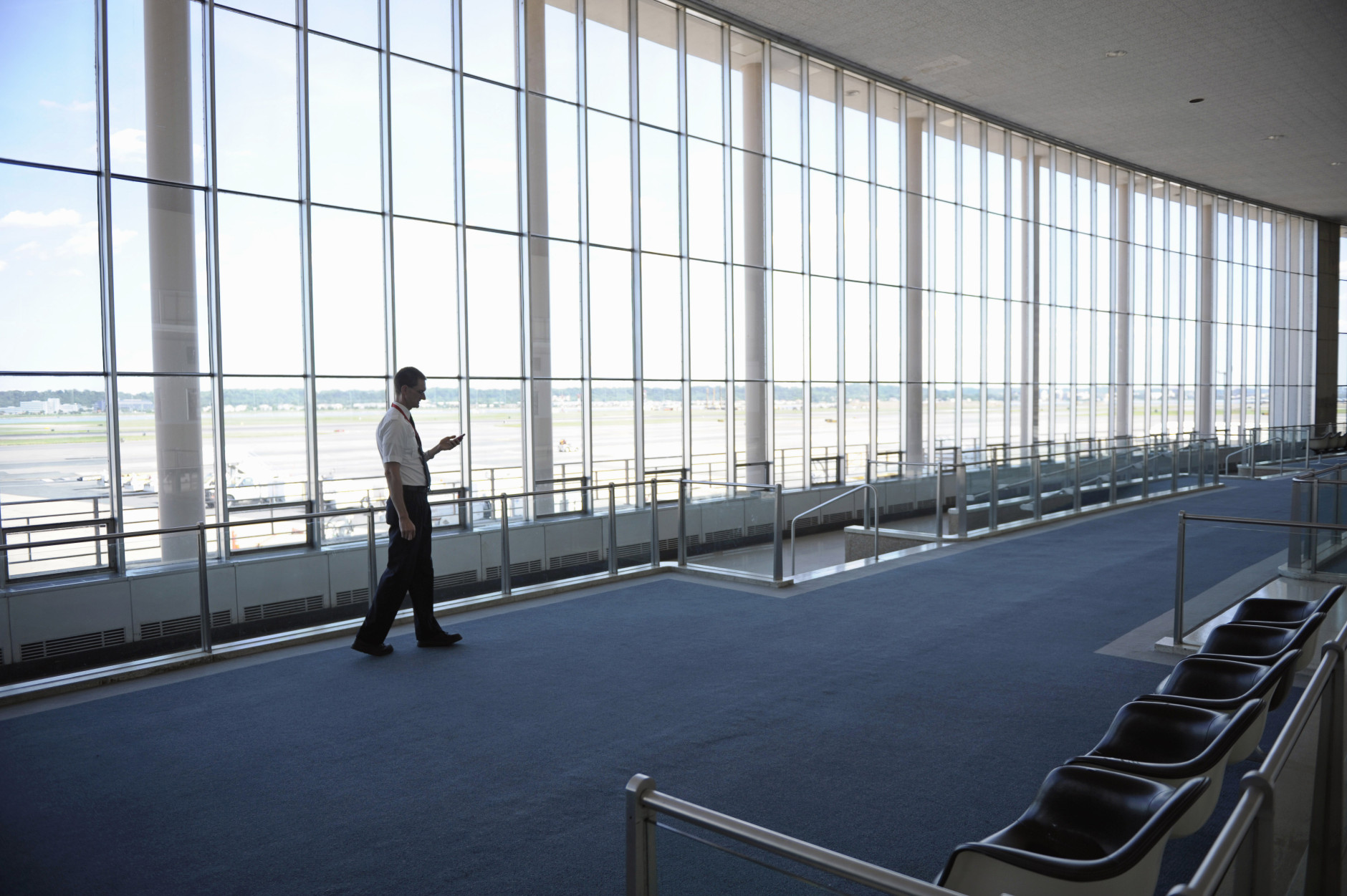 An employee of Washington's Ronald Reagan National Airport stands in an empty Terminal A, Tuesday, Aug. 23, 2011, after an earthquake in the Washington area. A 5.9 magnitude earthquake centered in Virginia forced evacuations of all the monuments on the National Mall in Washington and rattled nerves from Georgia to Martha's Vineyard, the Massachusetts island where President Barack Obama is vacationing. No injuries were immediately reported.  (AP Photo/Cliff Owen)