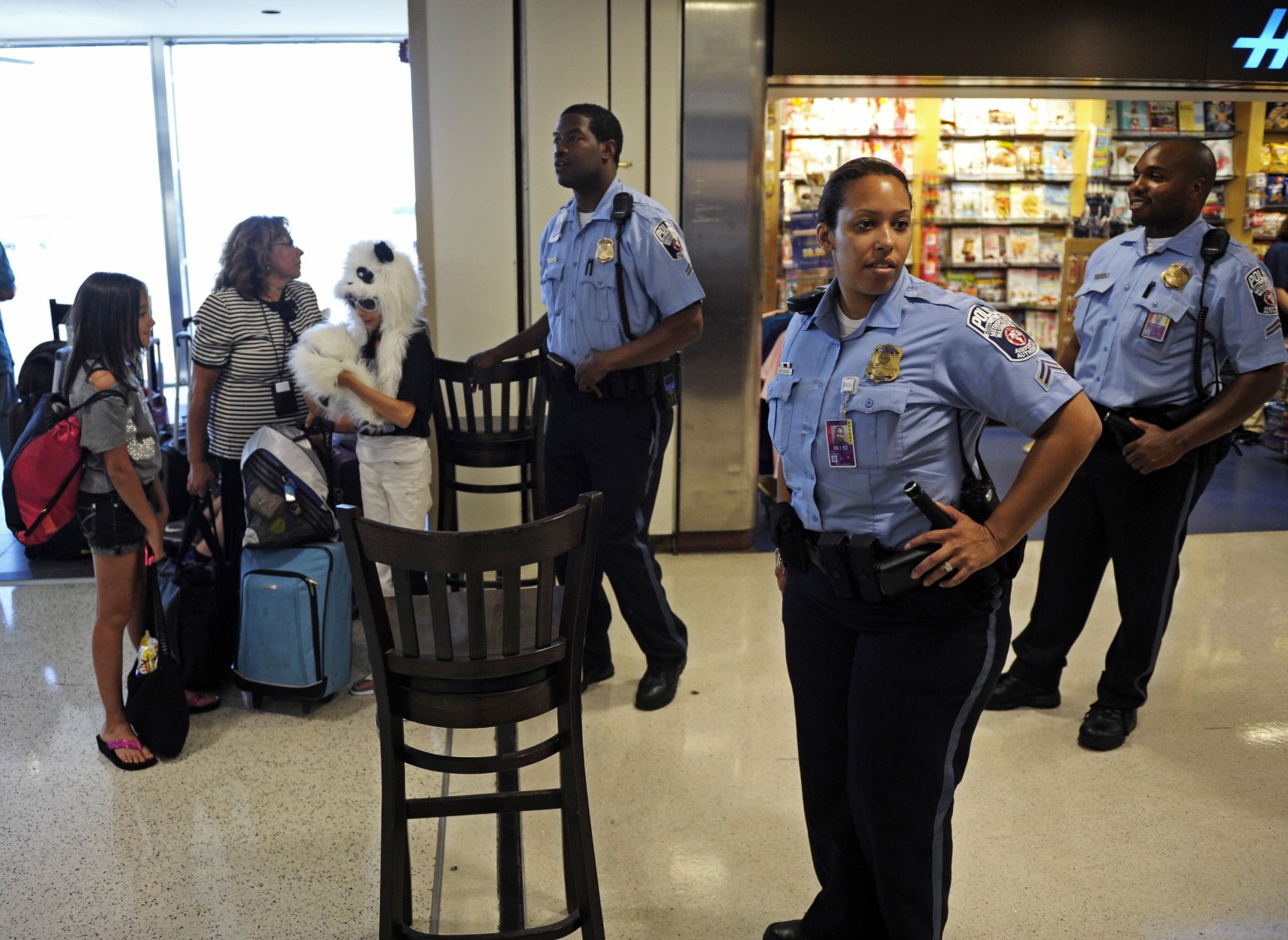 Ronald Reagan National Airport Police stop travelers from entering Terminal A, Tuesday, Aug. 23, 2011, as authorities checked for damage after an earthquake in the Washington area. A 5.9 magnitude earthquake centered in Virginia forced evacuations of all the monuments on the National Mall in Washington and rattled nerves from Georgia to Martha's Vineyard, the Massachusetts island where President Barack Obama is vacationing. No injuries were immediately reported.  (AP Photo/Cliff Owen)
