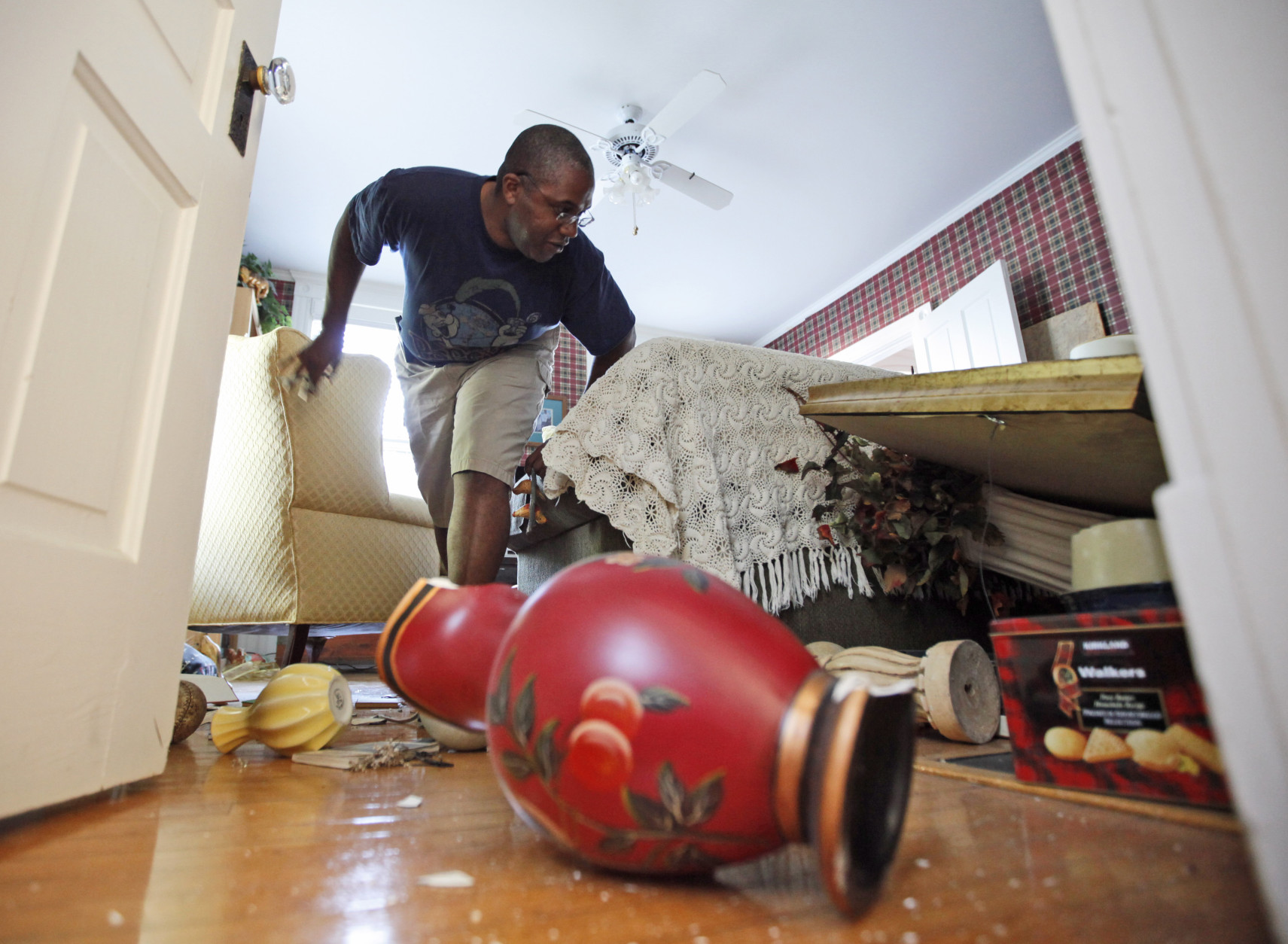 Tony Williams surveys damage at his Mineral, Va. home after an earthquake struck Tuesday, Aug. 23, 2011. Items in his home were knocked over and displaced, and the home suffered some structural damage after the most powerful earthquake to strike the East Coast in 67 years shook buildings and rattled nerves from South Carolina to New England. The quake was centered near Mineral, a small town northwest of Richmond. (AP Photo/Steve Helber)