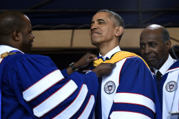 Howard University President Wayne A.I. Frederick, left, adjusts the sash of President Barack Obama, center, as he is awarded an honorary Doctor of Science degree from Howard University in Washington, Saturday, May 7, 2016, by Vernon Jordan, right.  Obama says the country is "a better place today" than when he graduated from college more than 30 years ago, citing his historic election as "one indicator of how attitudes have changed."  (AP Photo/Susan Walsh)