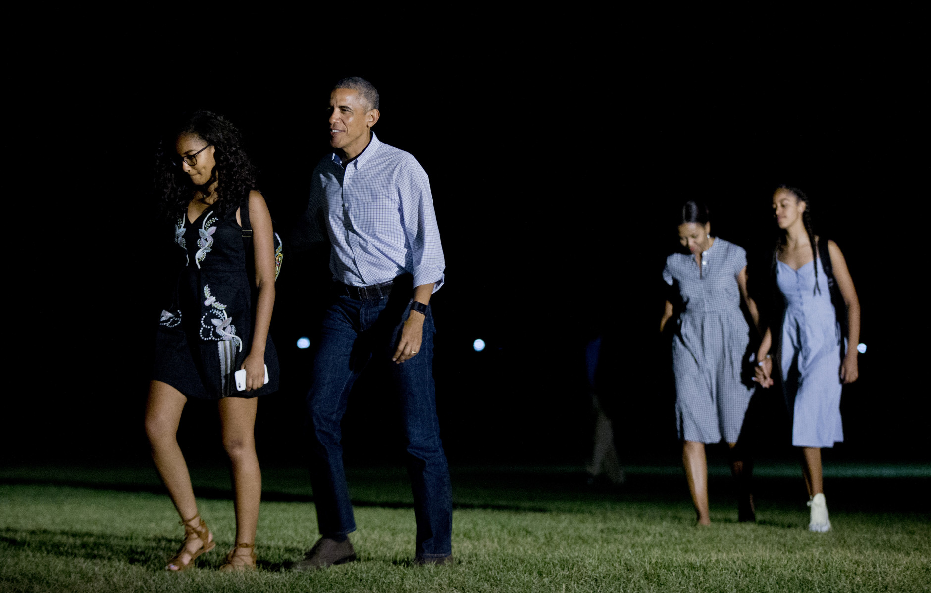 President Barack Obama, second from left, and his family, from left, Sasha Obama, first lady Michelle Obama and Malia Obama arrive at the White House in Washington, Sunday, June 19, 2016, from a trip to California, where he visited the Yosemite National Park to celebrate 100th anniversary of the creation of America's national park system.(AP Photo/Manuel Balce Ceneta)