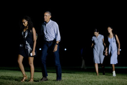 President Barack Obama, second from left, and his family, from left, Sasha Obama, first lady Michelle Obama and Malia Obama arrive at the White House in Washington, Sunday, June 19, 2016, from a trip to California, where he visited the Yosemite National Park to celebrate 100th anniversary of the creation of America's national park system.(AP Photo/Manuel Balce Ceneta)