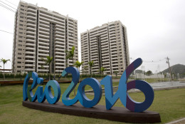 The Rio 2016 sign stands in front of the Olympic Village during a media tour in Rio de Janeiro, Brazil, Thursday, June 23, 2016. The organizers of the Rio de Janeiro Olympics have unveiled the athletes' village, where nearly 11,000 competitors and some 6,000 coaches and other team members will stay during the Aug. 5-21 games. (AP Photo/Silvia Izquierdo)